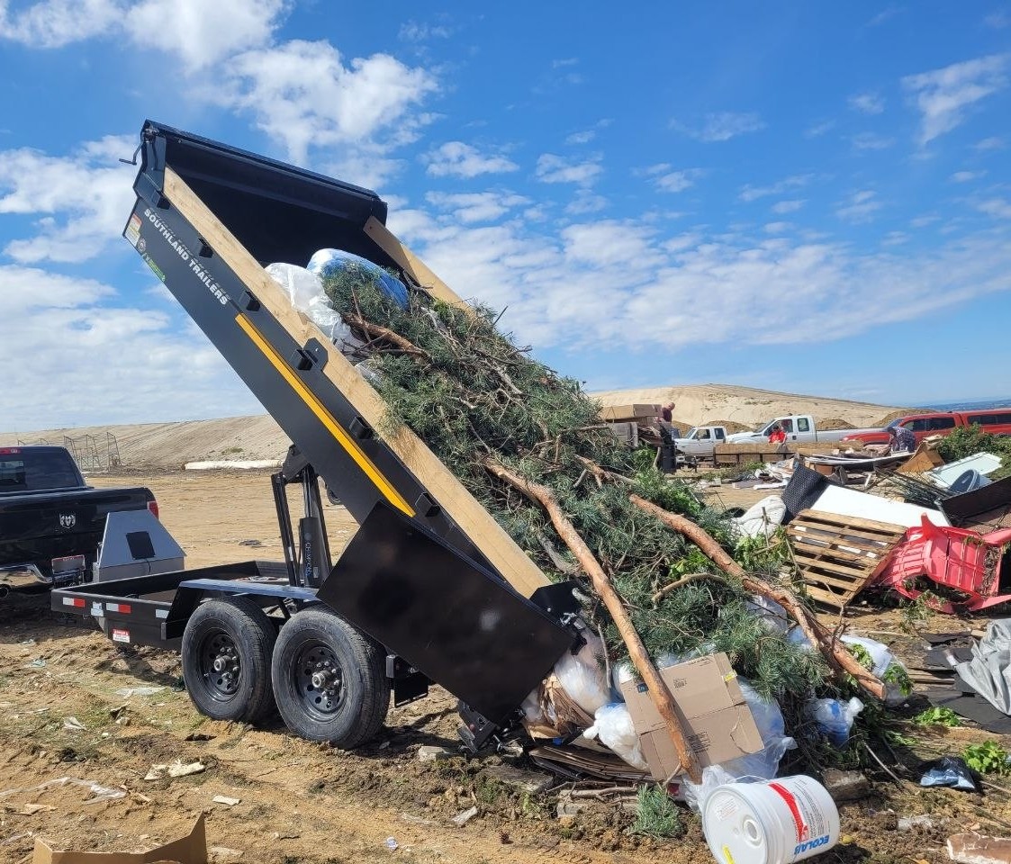 Dynamo Hauling dump trailer unloading a yard waste load at the landfill in Boise